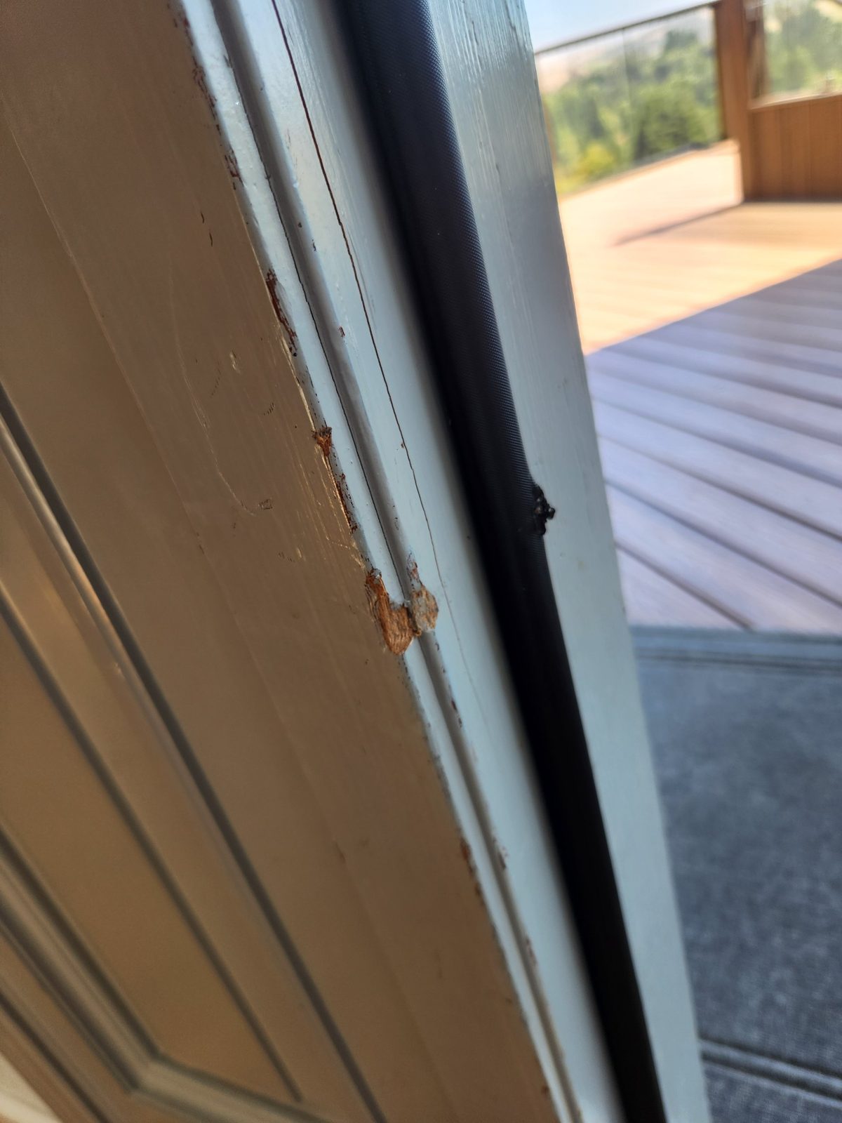 Rust-stained, worn wood on a door frame in Santa Rosa before repair