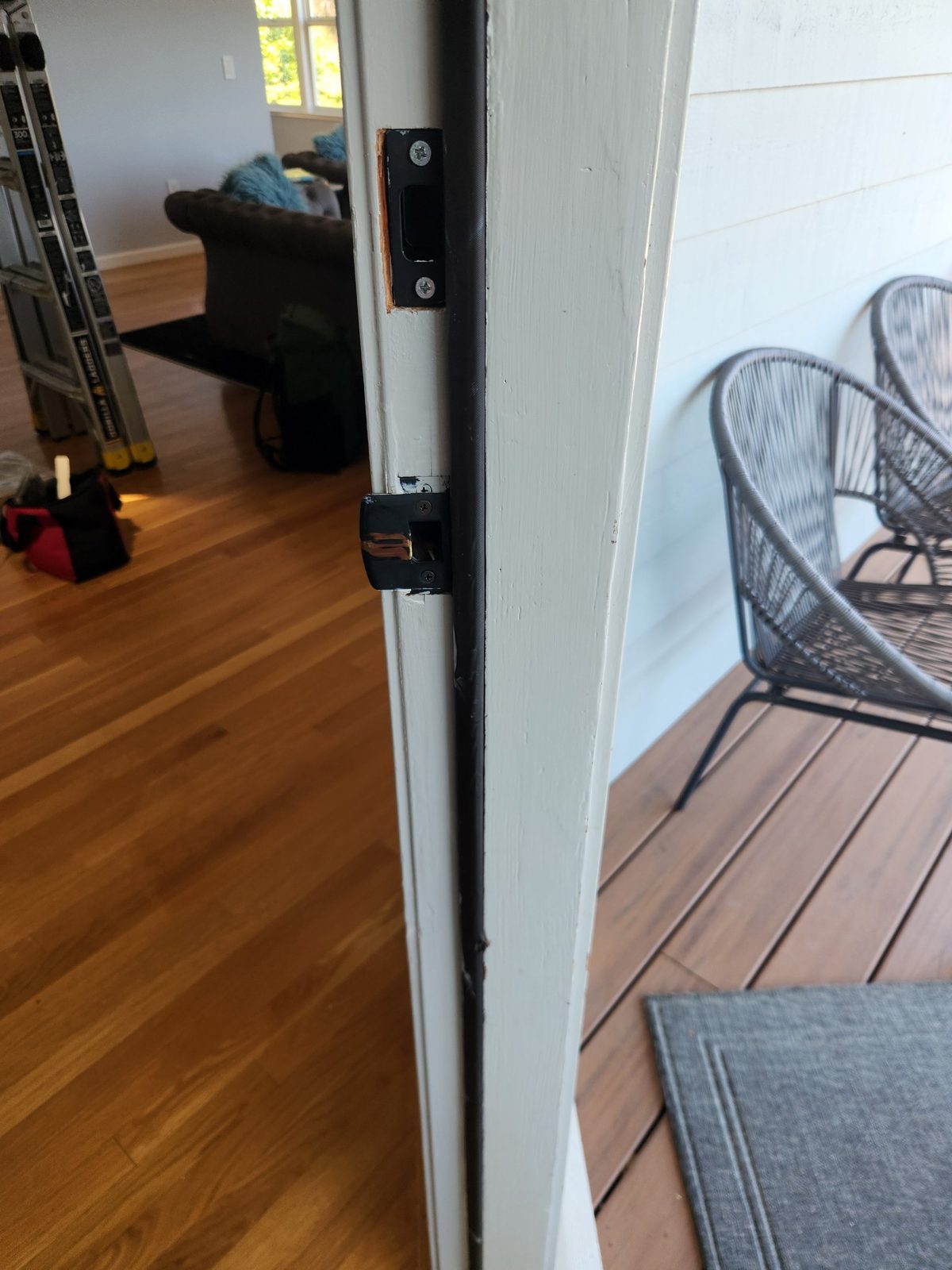 Door frame repair in progress in Santa Rosa with pin nails and wood putty applied before paint