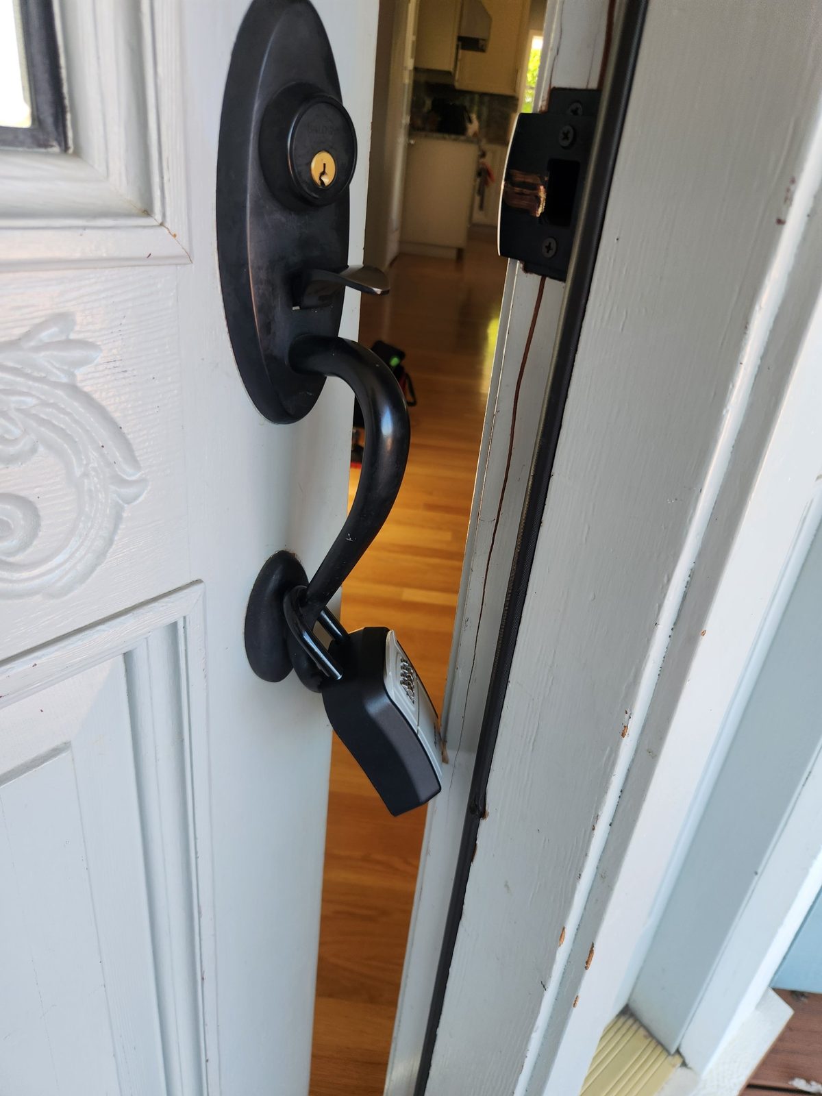 Damaged door frame around the strike plate and latch hardware in Santa Rosa before repair