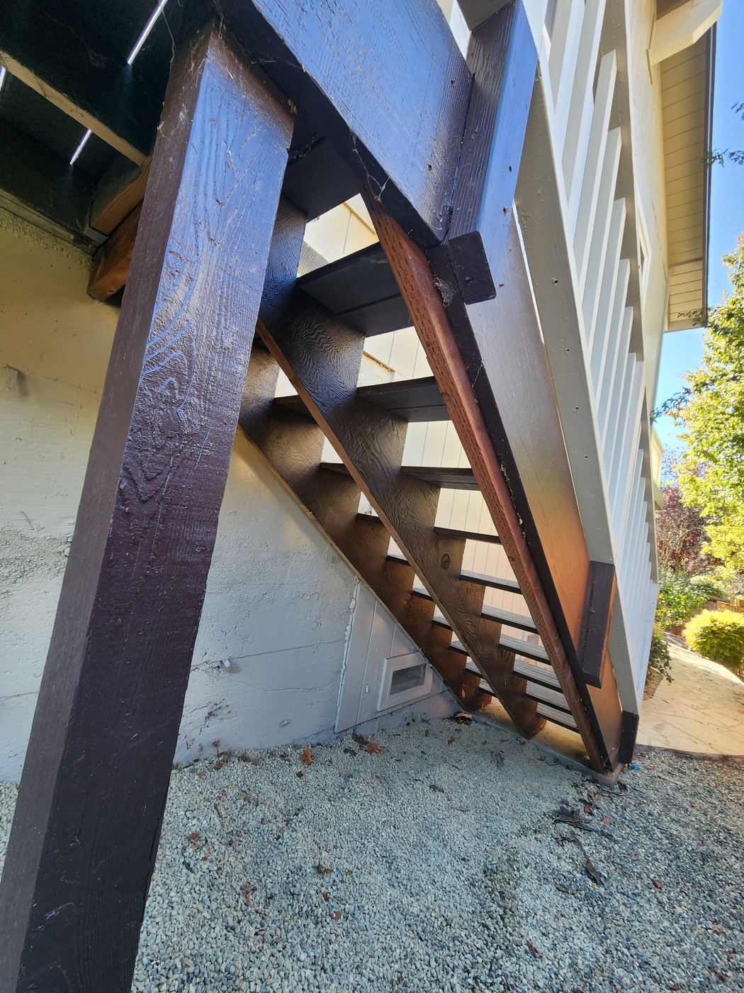 New pressure-treated stair stringer installed with moisture tape
