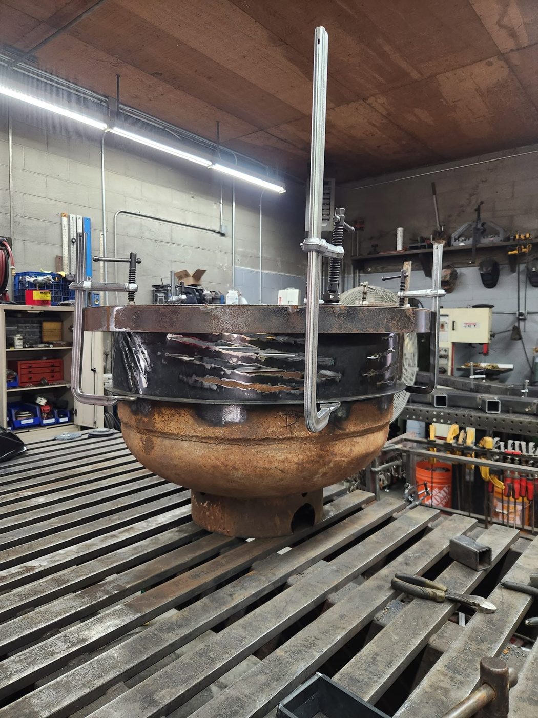 Fire pit clamped together on the welding table during assembly