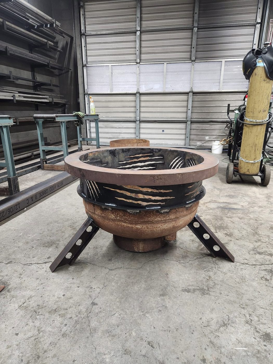 Finished custom propane tank fire pit on I-beam legs with claw-mark cutouts, Santa Rosa CA