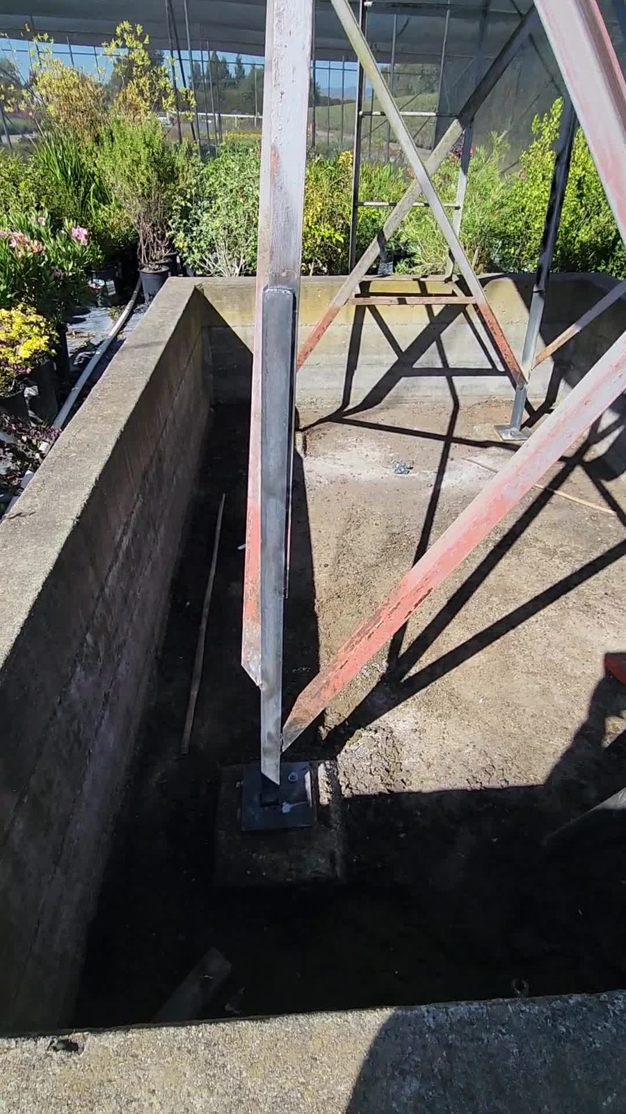 Close-up of a finished welded base plate and new angle-iron post on the diesel tank stand, Sonoma County