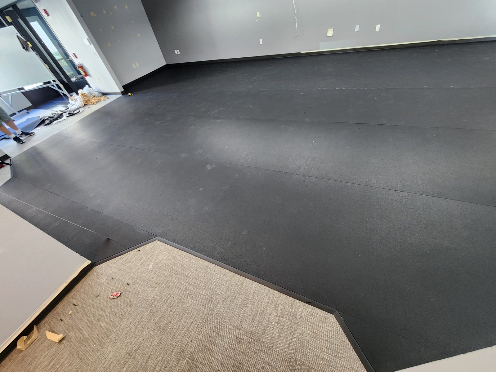 Full view of the finished commercial rubber flooring installation from the opposite corner