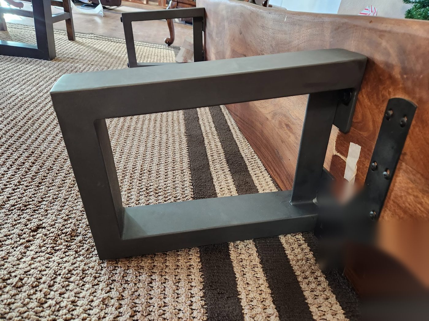 Original steel bench leg bolted to the underside of the bench, used as the pattern