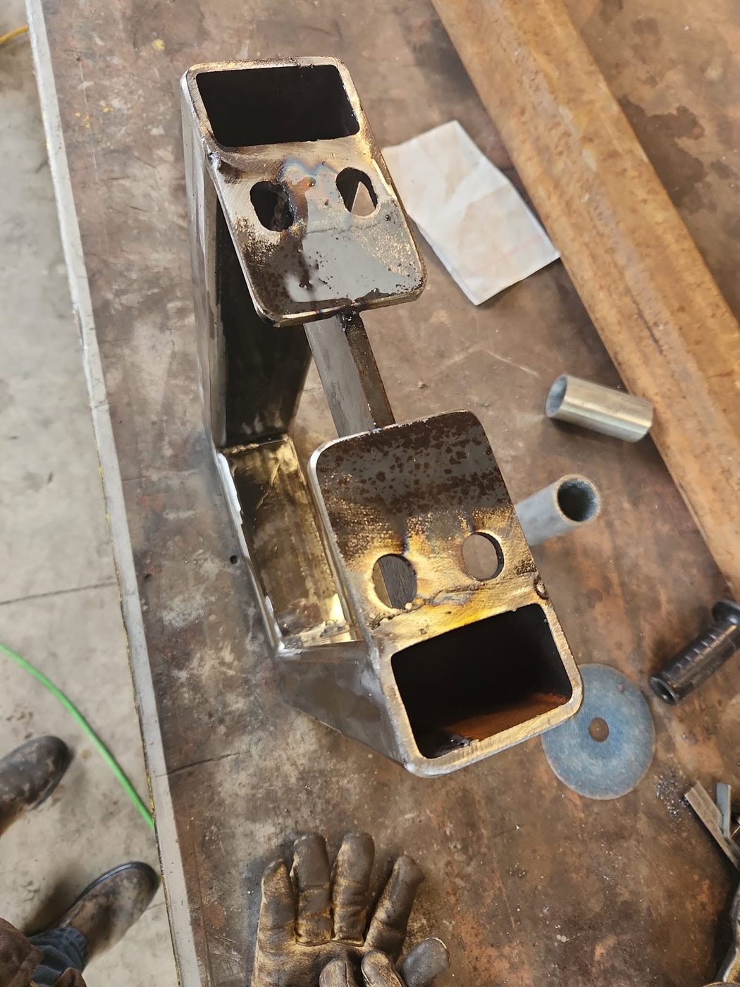 Close-up of a bench leg mounting plate with drilled holes