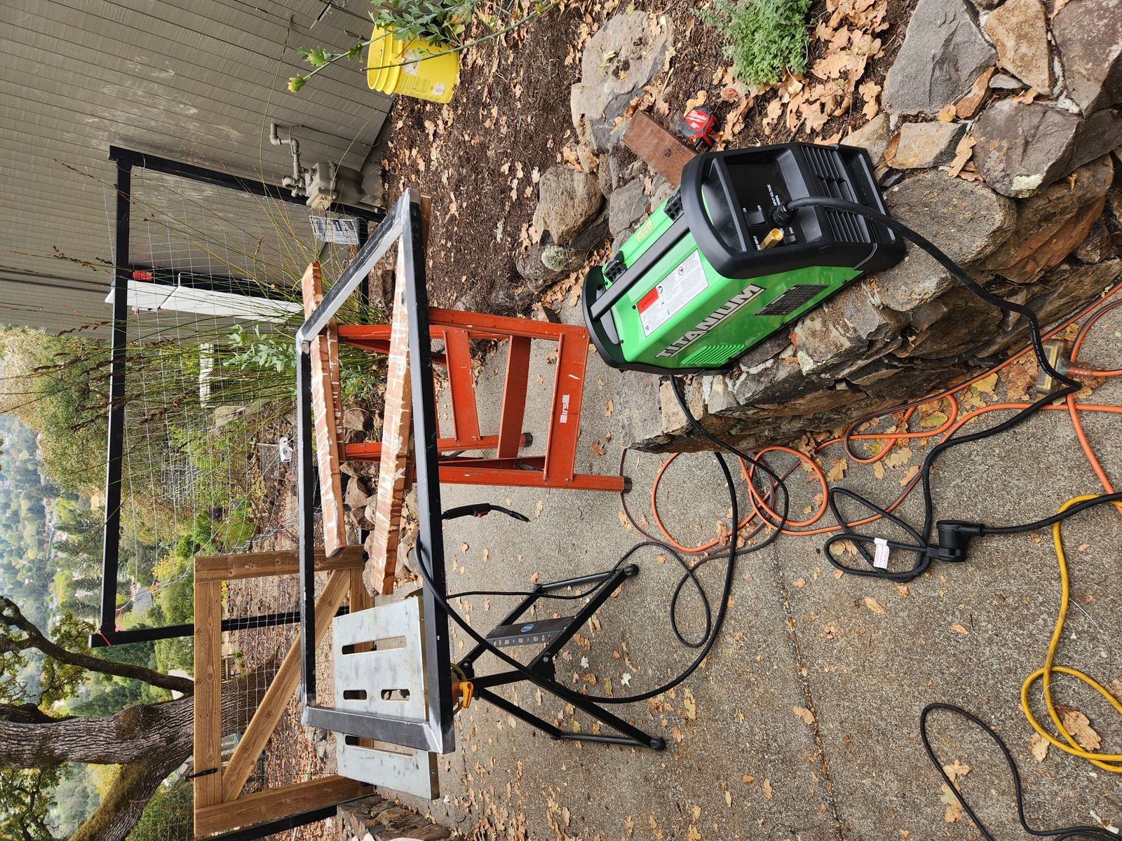 Mobile welding setup with Titanium welder and sawhorses on a Santa Rosa job site
