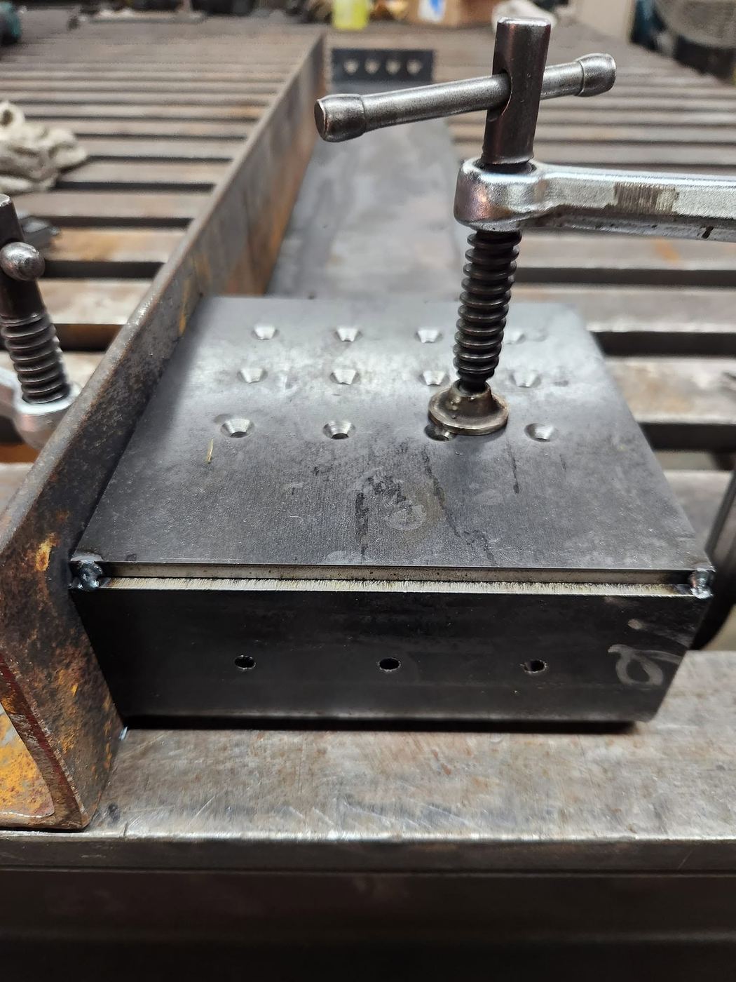 Steel base plate clamped and squared for welding