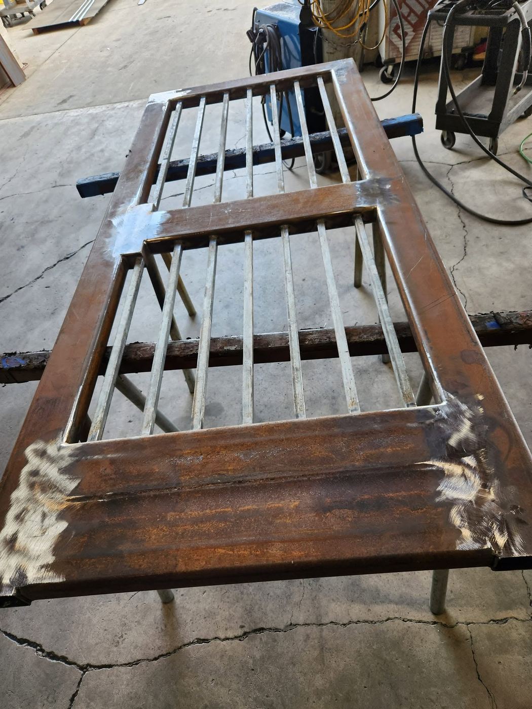 Welded steel gate frame with vertical bar infill