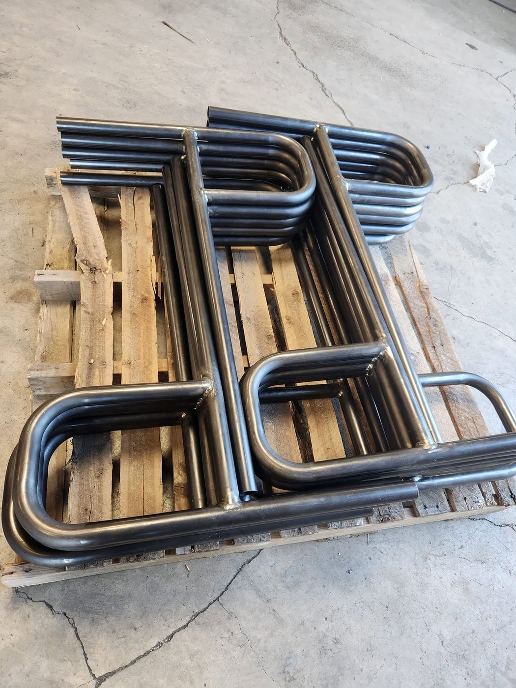Custom bent round steel tubing components on a pallet